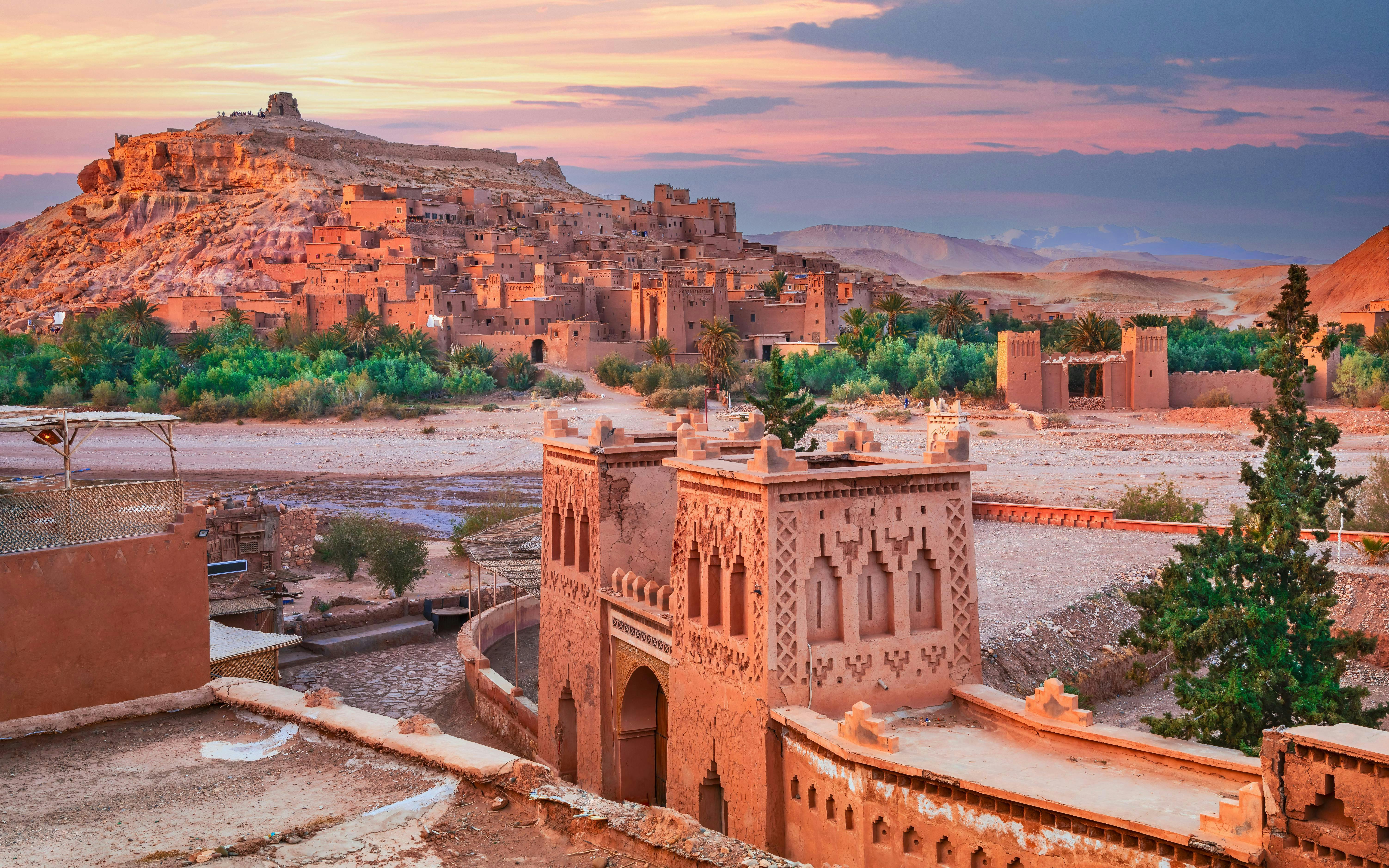 Ait Ben-Haddou kasbah with ancient clay buildings at sunset, Morocco.