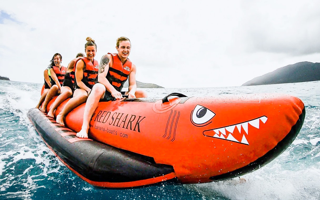 Tourists riding a banana boat in the Whitsundays.