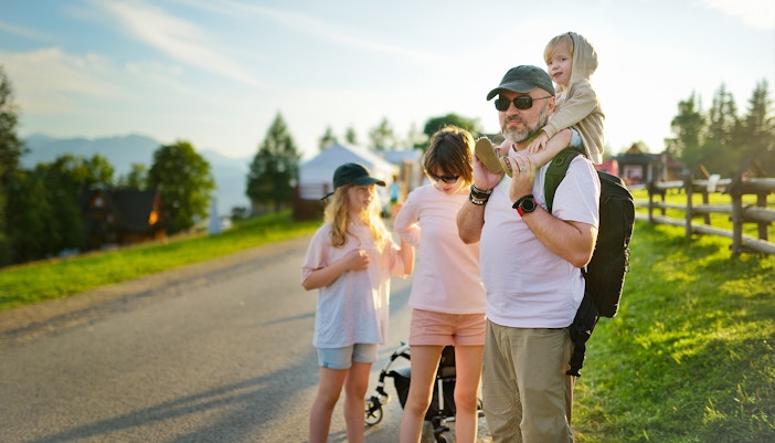 Family enjoying a walk on Gubałówka Hill, Zakopane, with scenic mountain views.