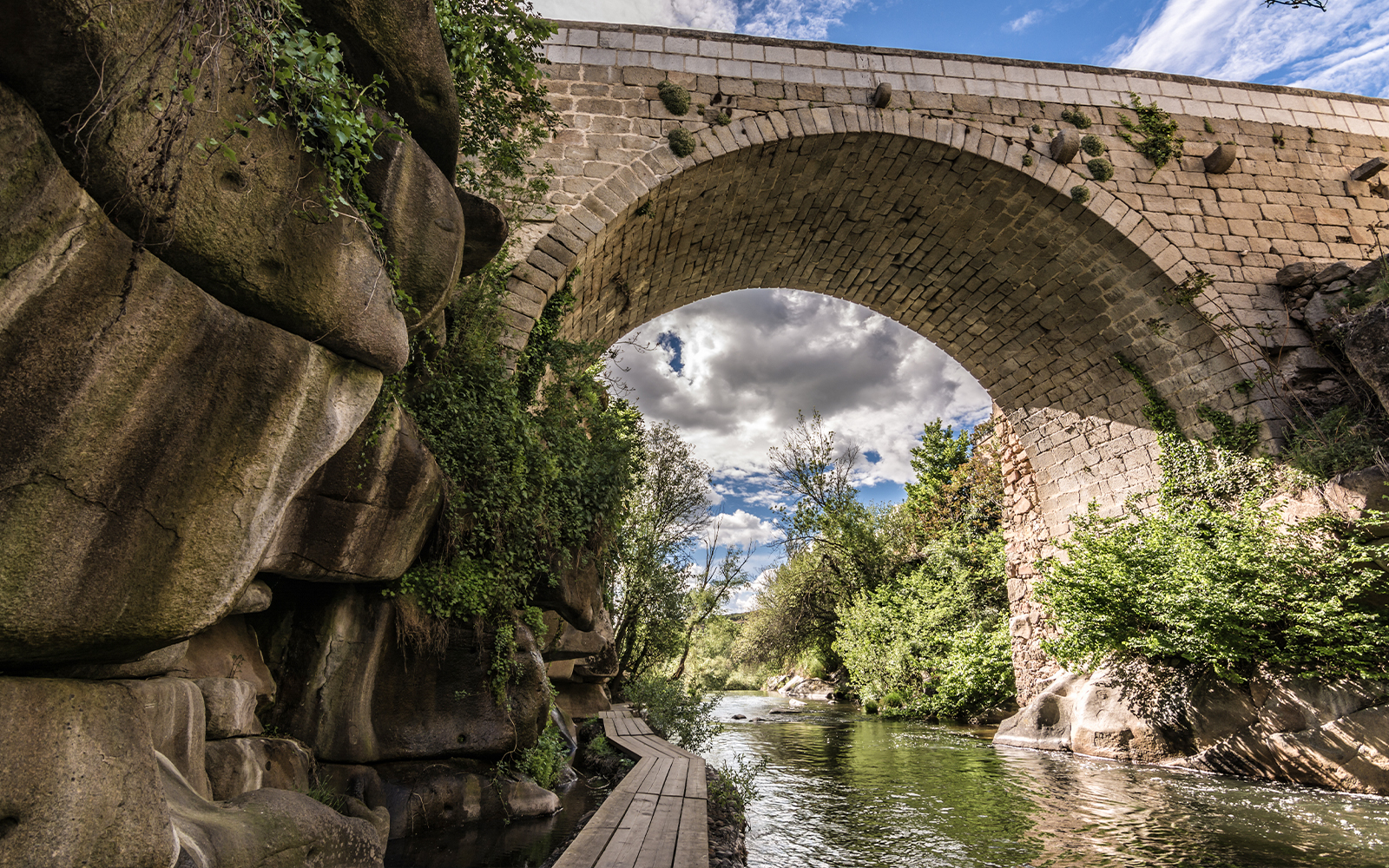 Stone bridge over the Eresma River on the Route of the Mills in Segovia.