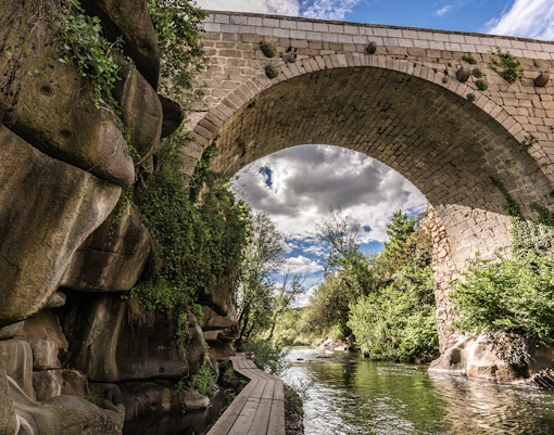 Stone bridge over the Eresma River on the Route of the Mills in Segovia.