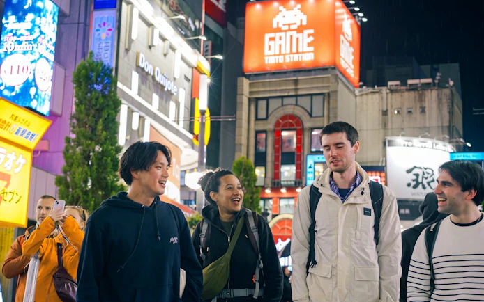 Group enjoying Tokyo's vibrant nightlife in Shinjuku during the Omakase Sushi & A5 Wagyu Foodie Tour.