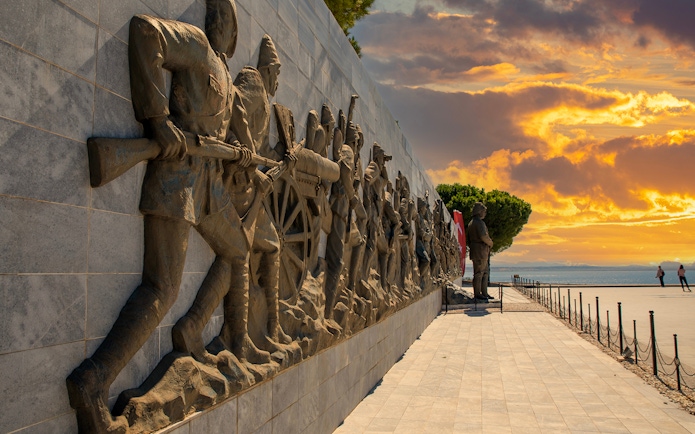 Gallipoli monument with soldiers in relief at sunset, part of a day tour from Istanbul.