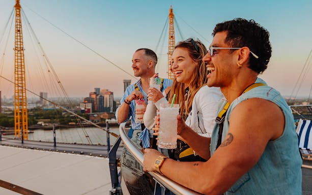 Guests enjoying drinks atop the O2 with a view of London skyline.