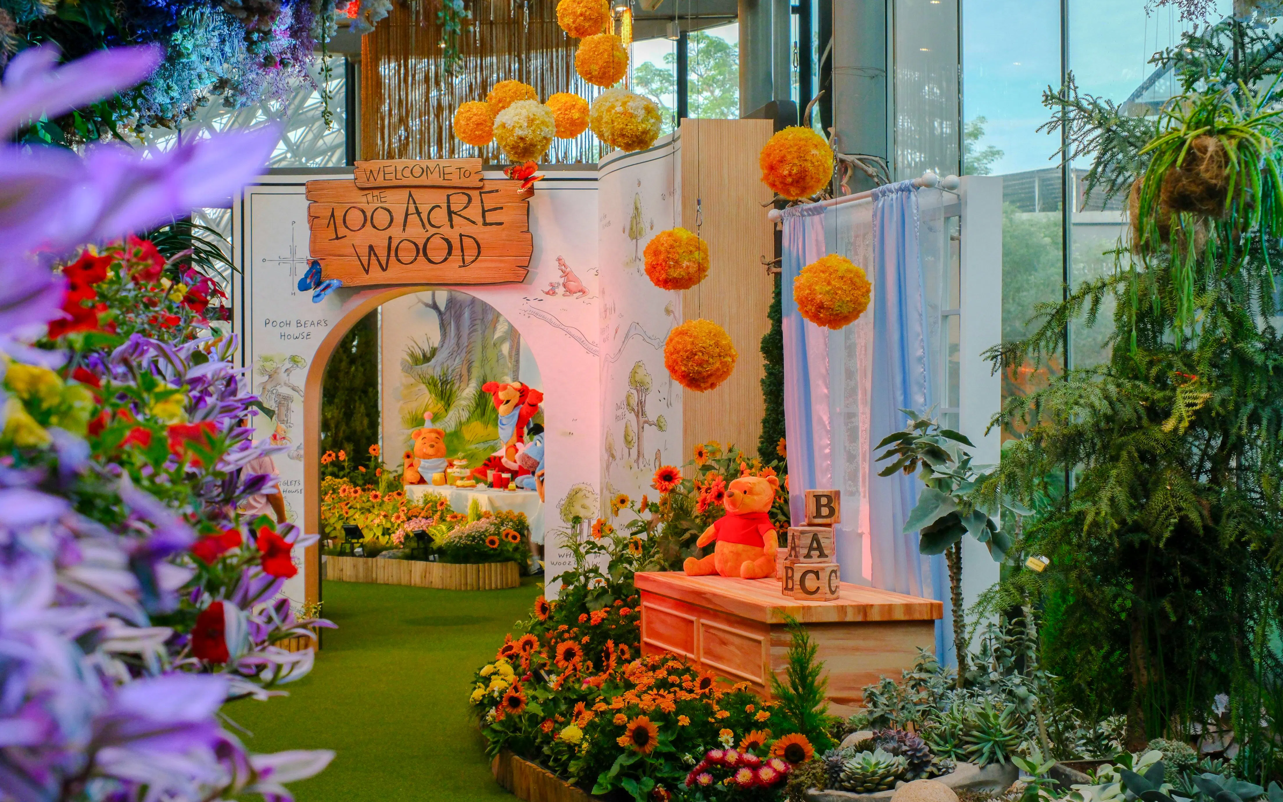 Disney Garden of Wonder with Winnie the Pooh theme, featuring colorful flowers and character displays.