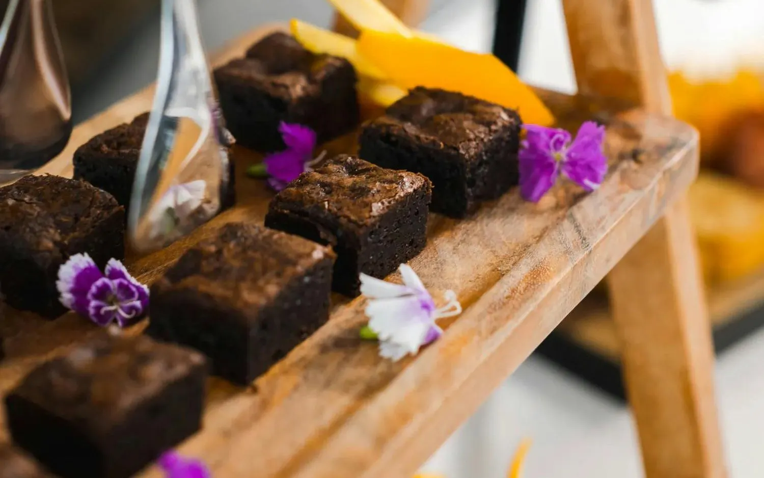 Brownies on wooden tray with flowers, Milford Sound VIP Cruise buffet.