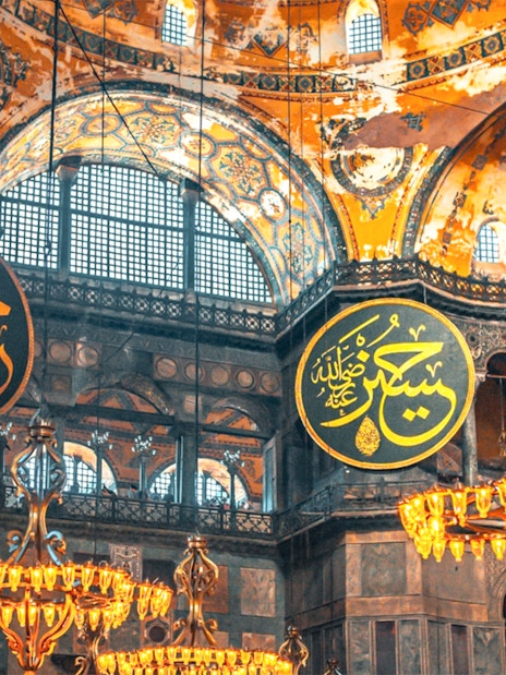 Hagia Sophia interior with chandeliers and Arabic calligraphy, Istanbul.