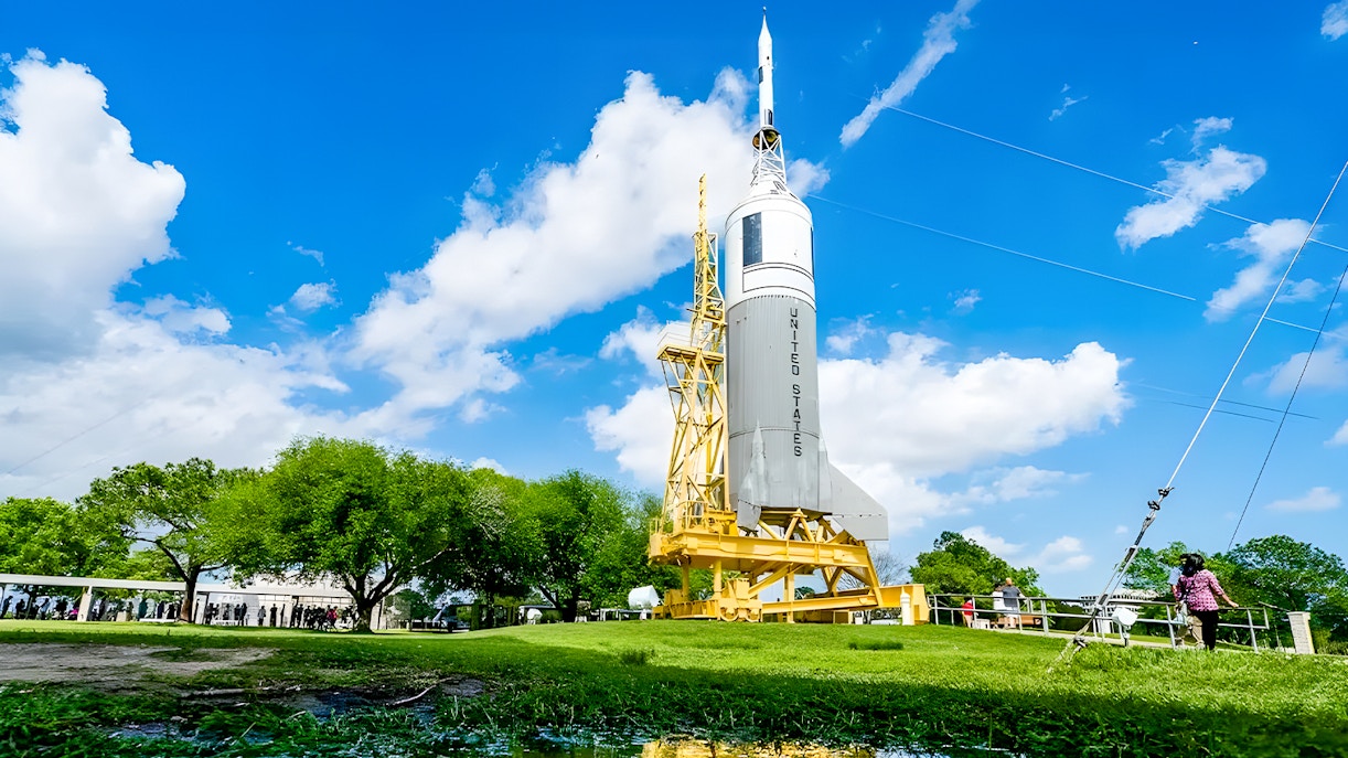 People waiting in line looking at the US Rocket outside the Houston Space Center