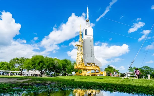 Visitors queue near the US Rocket at Houston Space Center.