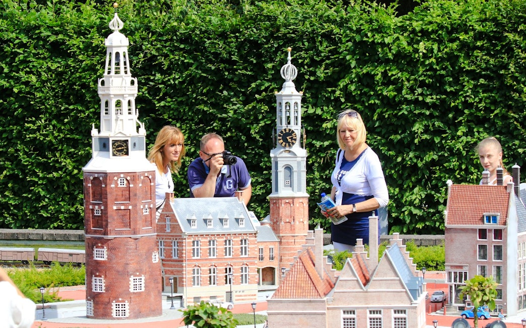 Tourists exploring miniature landmarks at Mini-Europe park in Brussels.