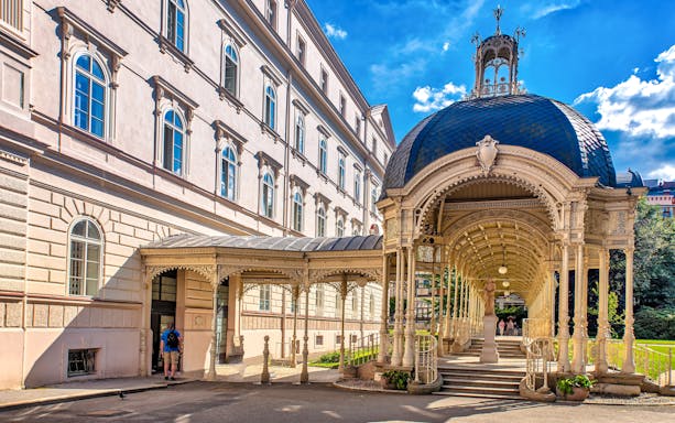 Park Colonnade in Karlovy Vary with ornate architecture and a domed roof.
