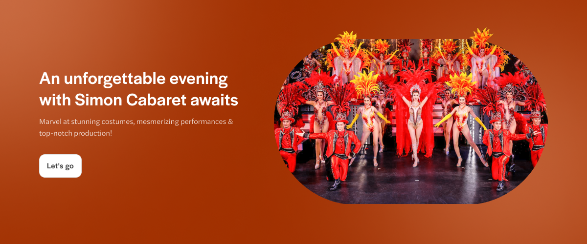 Simon Cabaret performers in vibrant costumes on stage, Phuket, Thailand.