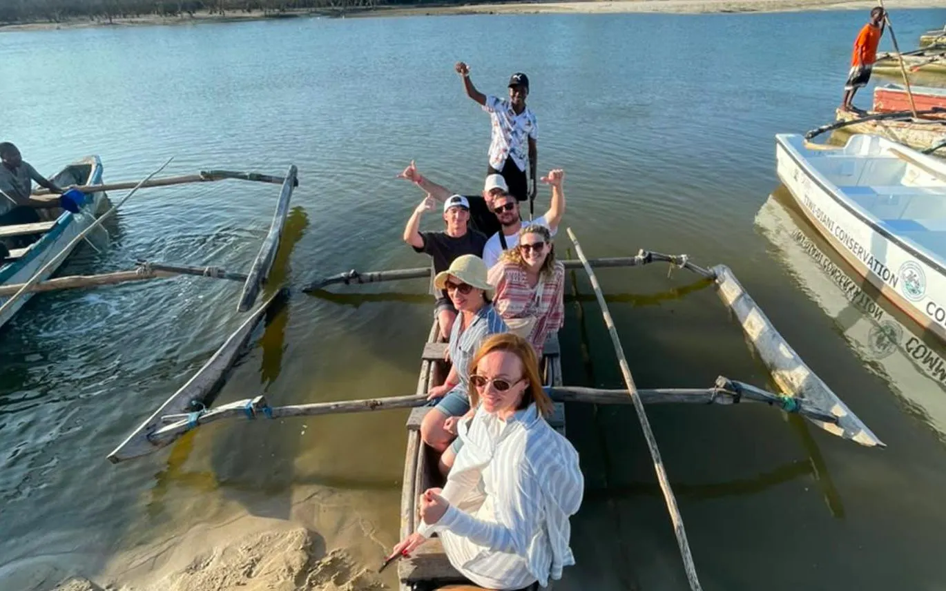 Tourists on a traditional boat during Mombasa to Diani snorkeling and sunset cruise tour.
