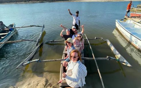 Tourists on a traditional boat during Mombasa to Diani snorkeling and sunset cruise tour.