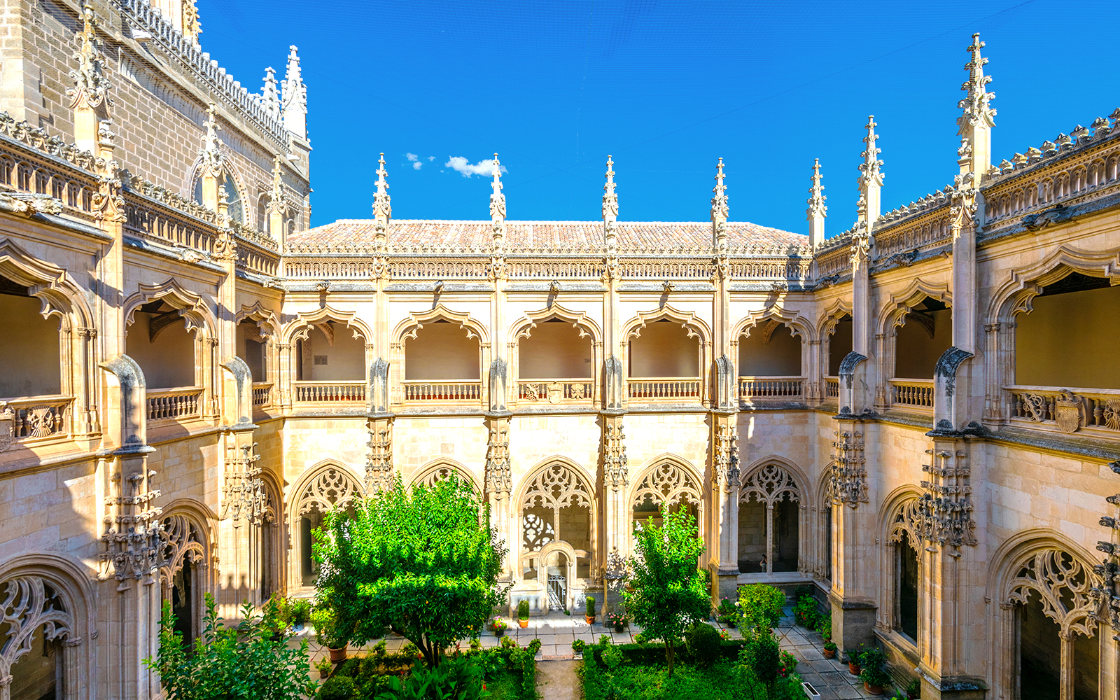 Monastery of St. John of the Kings in Toledo with Gothic architecture and intricate stone carvings.