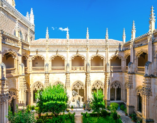 Monastery of St. John of the Kings in Toledo with Gothic architecture and intricate stone carvings.