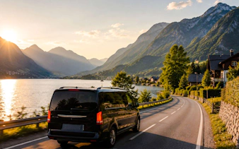 Van driving along a lakeside road with mountains near Hallstatt, Austria.