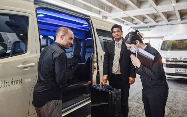 Private transfer service at Suvarnabhumi Airport with van and luggage.