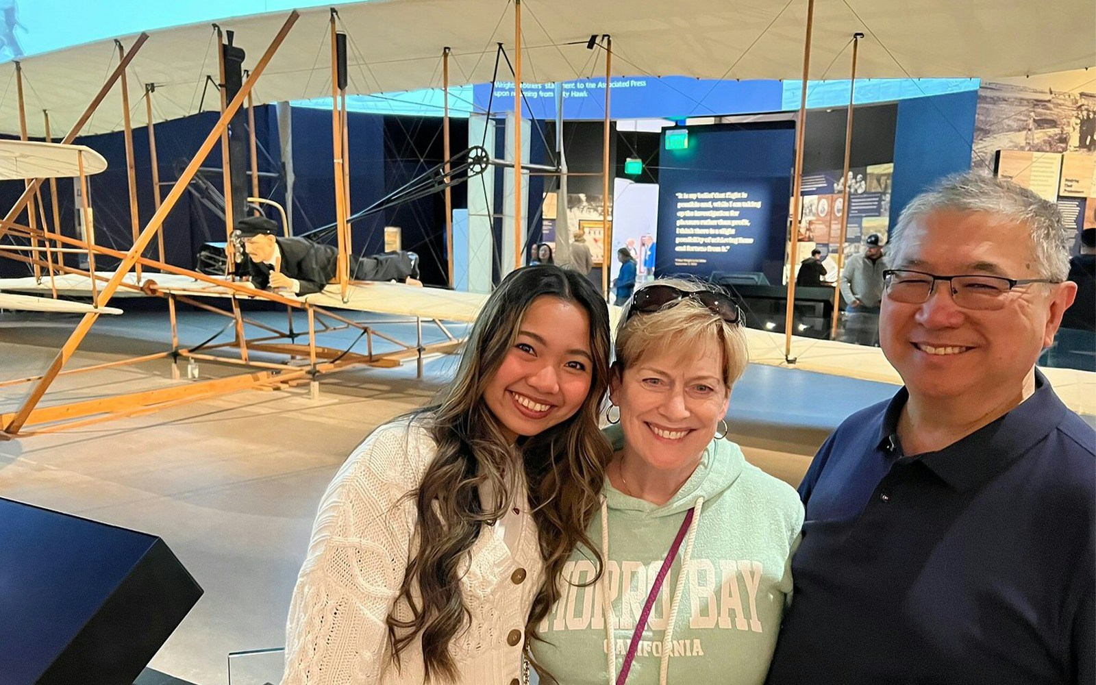 Visitors at Smithsonian's National Air and Space Museum with Wright brothers' plane exhibit.