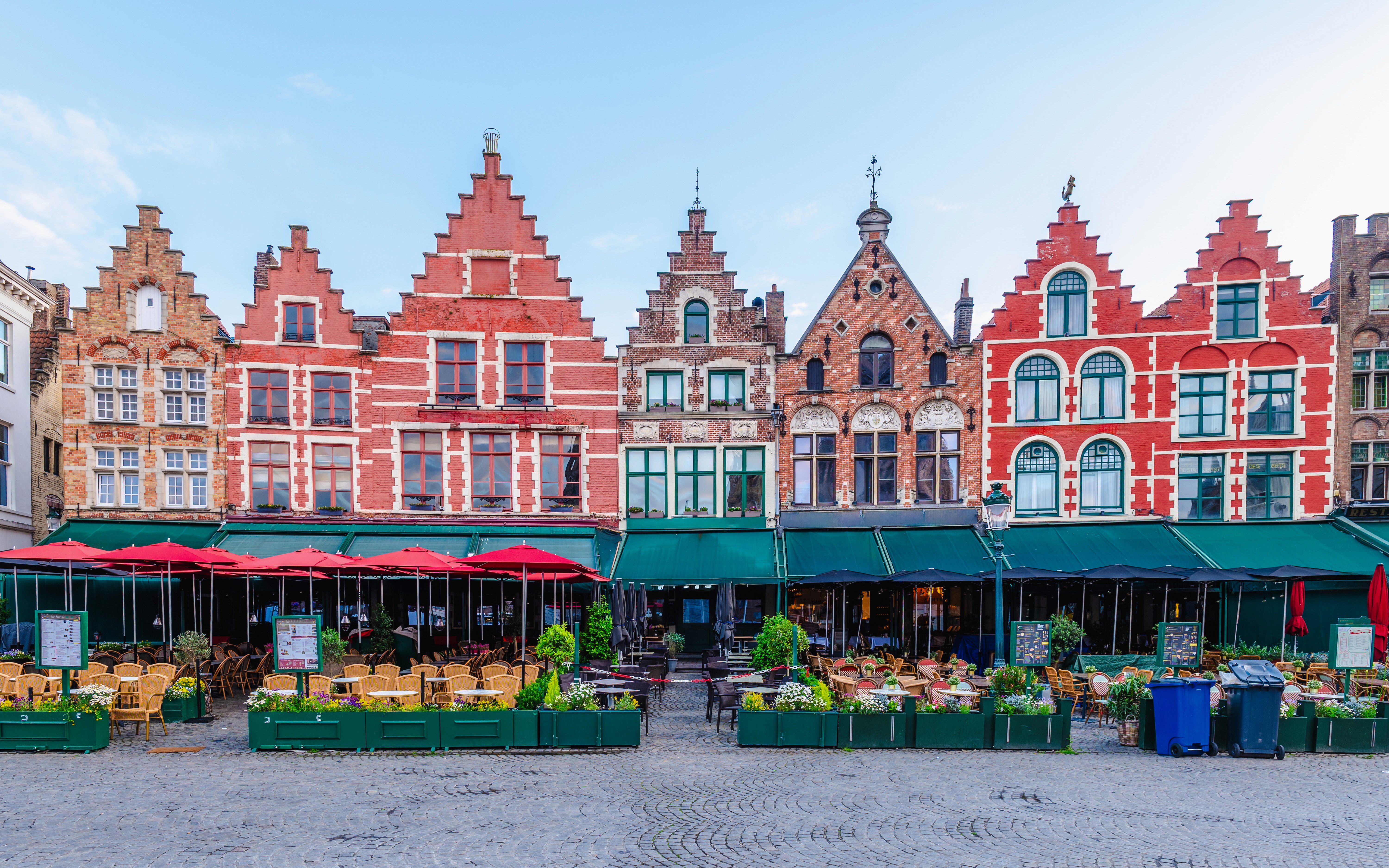 Historic gabled buildings and outdoor cafes at Markt, Market Square in Bruges.