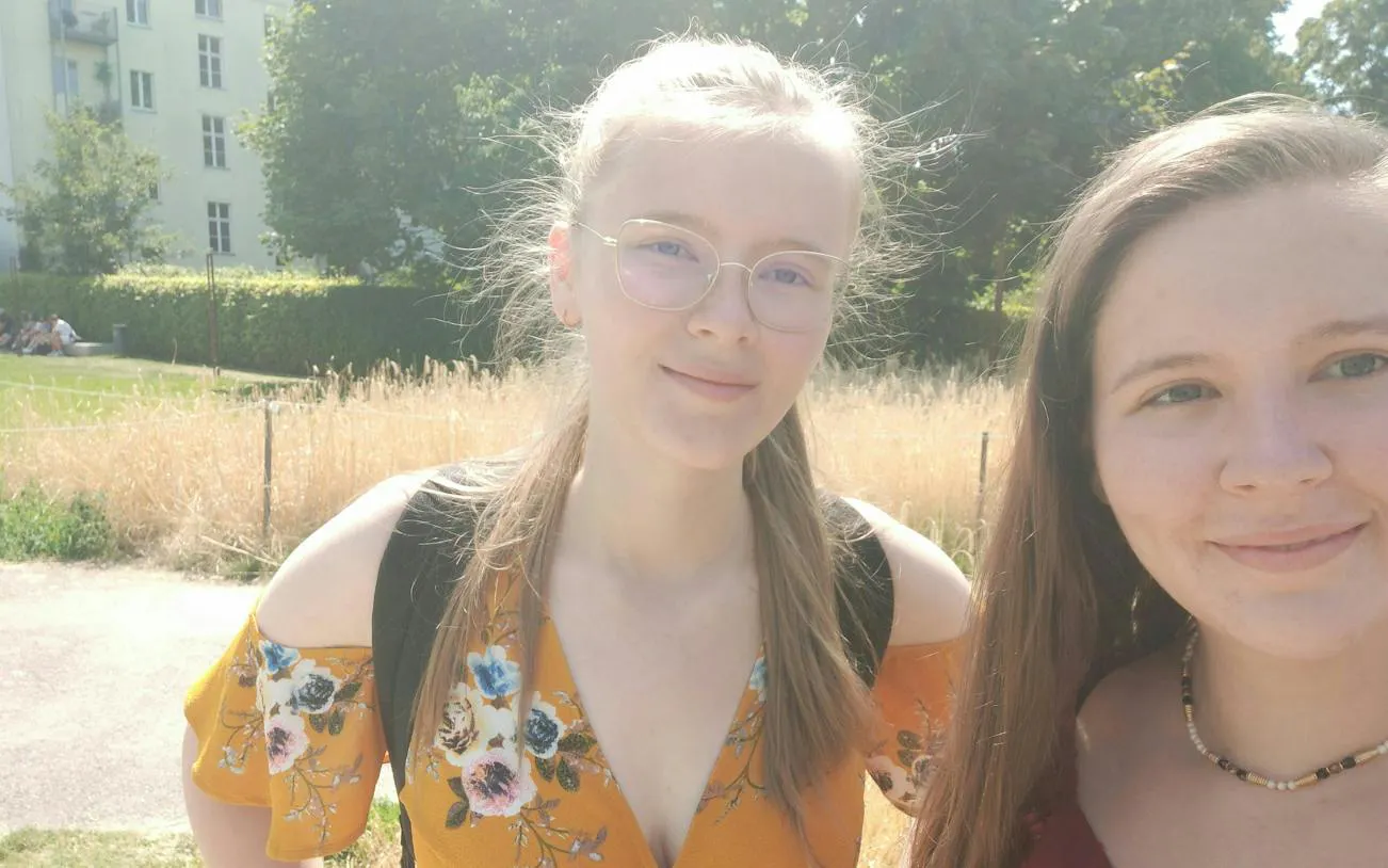 Two people smiling outdoors during the Berlin spy mission city exploration game.
