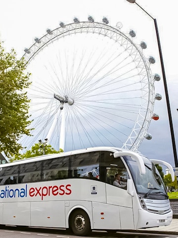National Express bus in front of the London Eye, England.