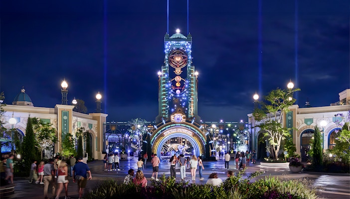 Guests entering Epic Universe park entrance at night, Universal Orlando, Florida.