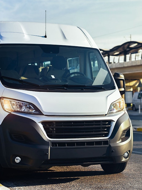 Minivan for airport transfer parked near terminal.