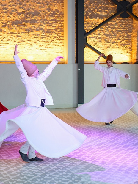 Whirling Dervishes performing traditional dance in Istanbul ceremony.