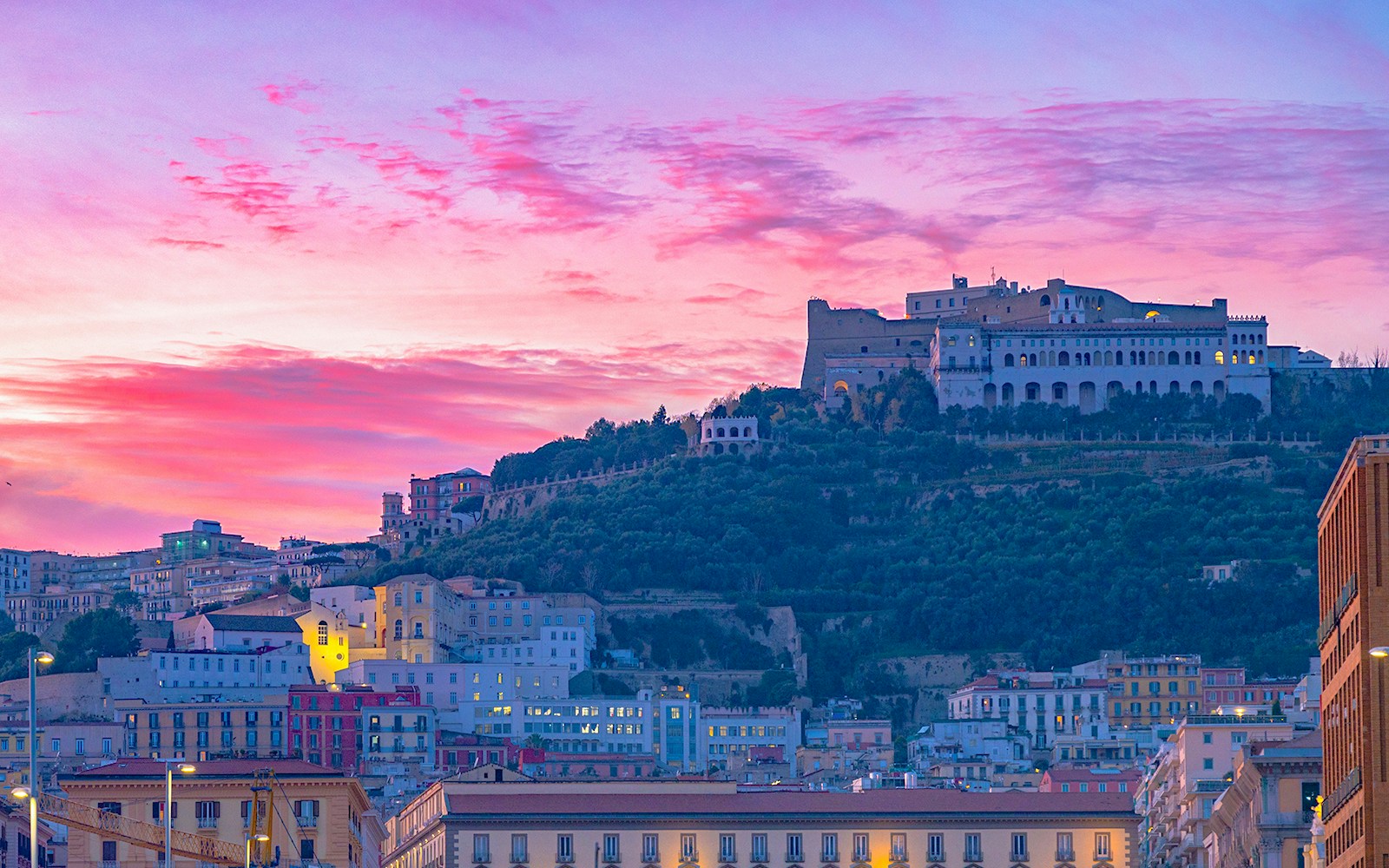 Castel Sant'Elmo overlooking Naples at sunset, highlighting its historic architecture.