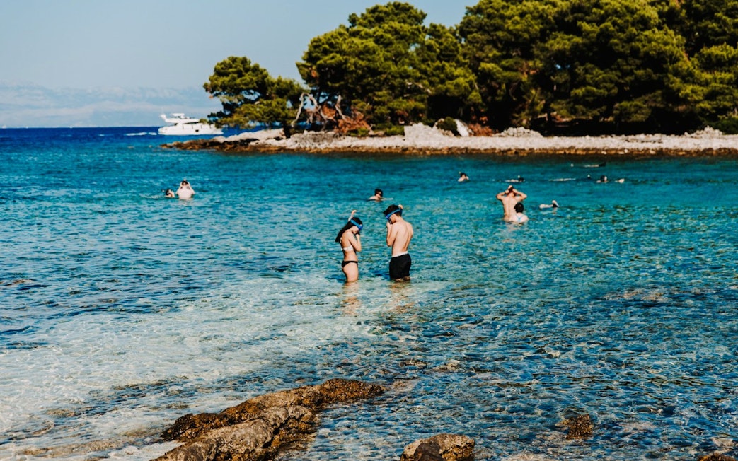 Guests snorkeling in clear waters during Blue Lagoon, Solta & Trogir Speedboat Tour.