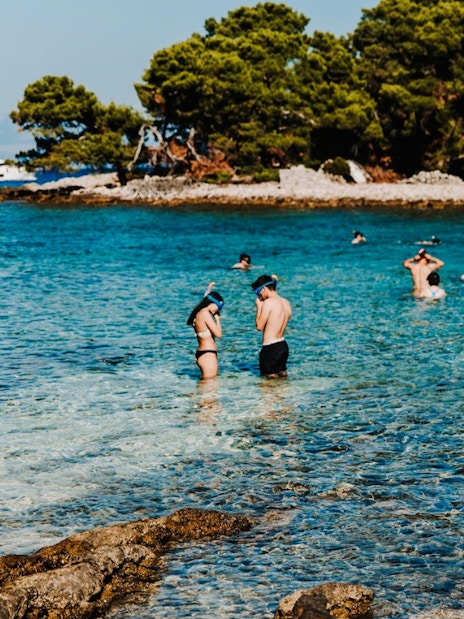 Guests snorkeling in clear waters during Blue Lagoon, Solta & Trogir Speedboat Tour.