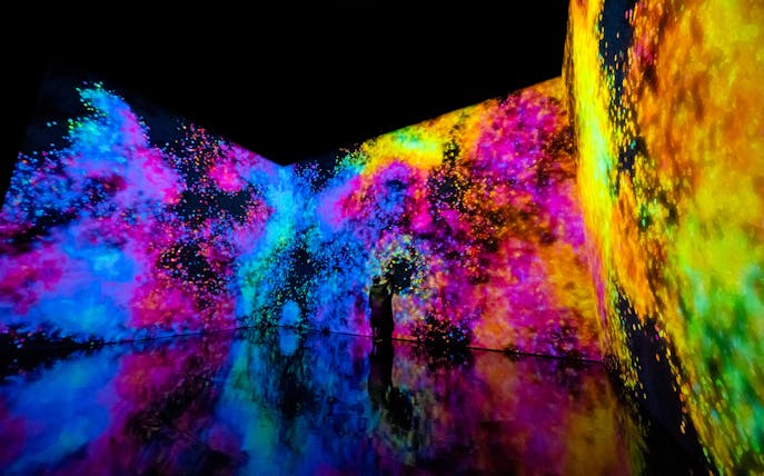 Interactive digital art display at Marina Bay, Singapore, with vibrant colors and reflections.