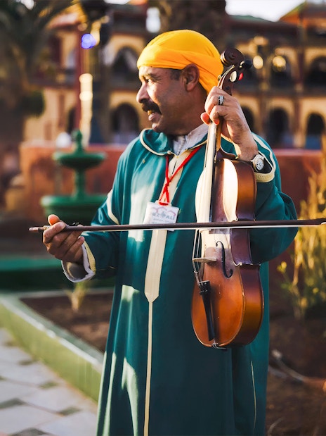 Musician playing violin at Chez Ali Dinner & Fantasia Show in Marrakech.