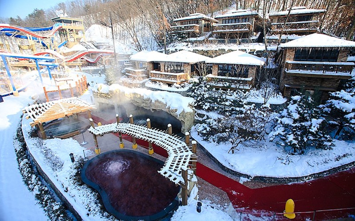Snow-covered cottages and hot springs at Vivaldi Park Ski Resort.