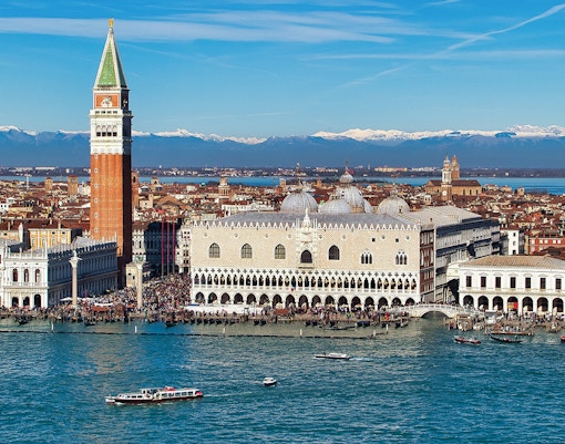 Doge's Palace in Venice with gondola on canal in foreground.