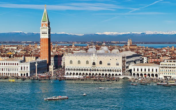 Doge's Palace aerial view with boats on the Grand Canal, Venice, Italy.