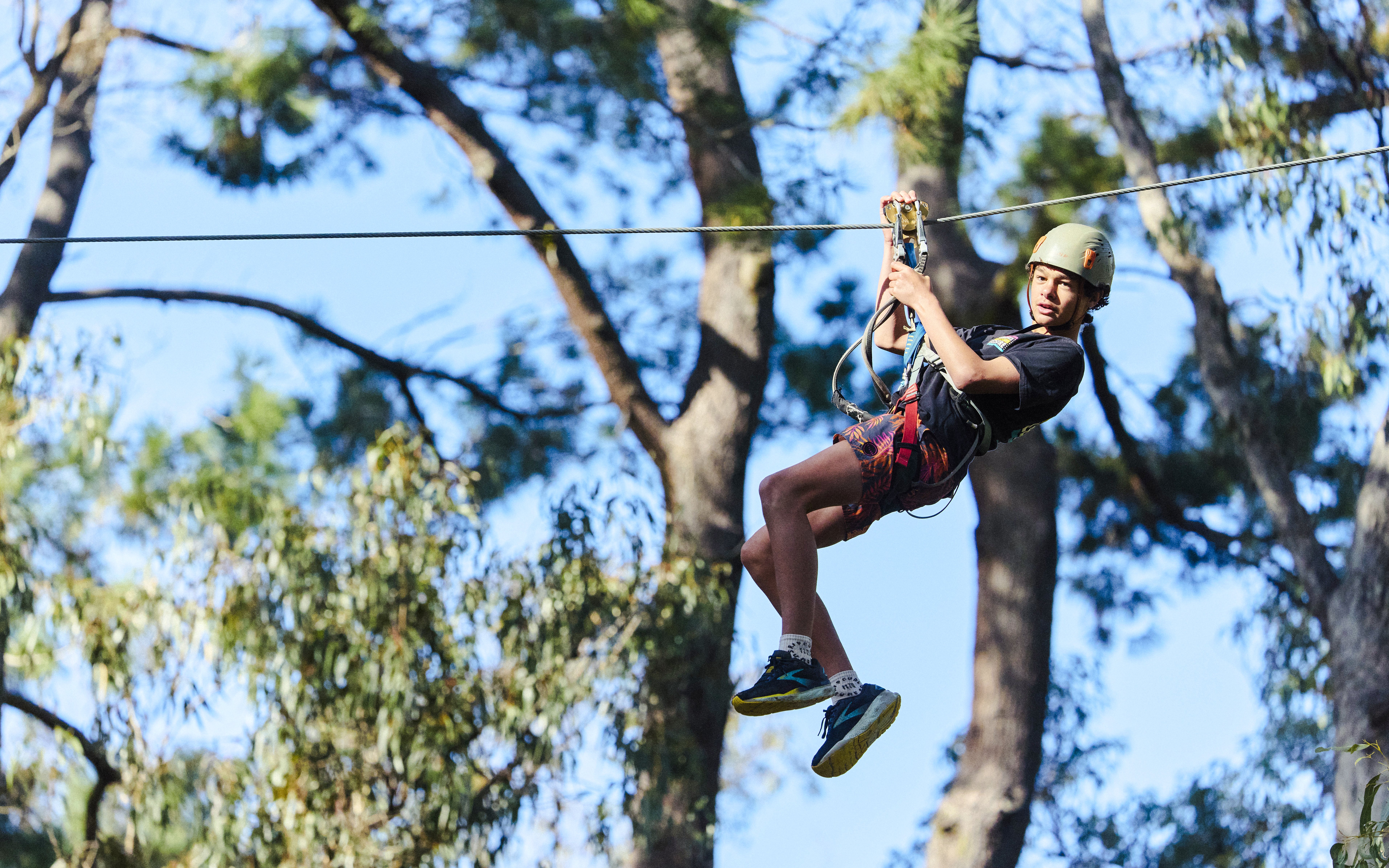 Participant ziplining at Busselton Forest Adventures High Ropes Course.