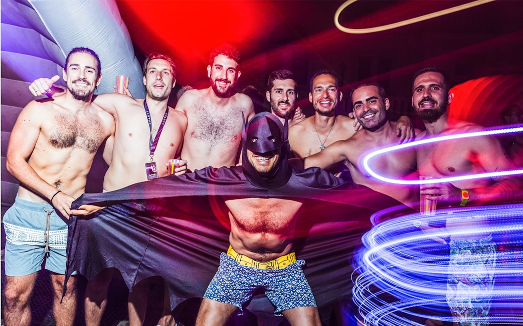 Group of friends enjoying Sparty bath party in Budapest with colorful lights.