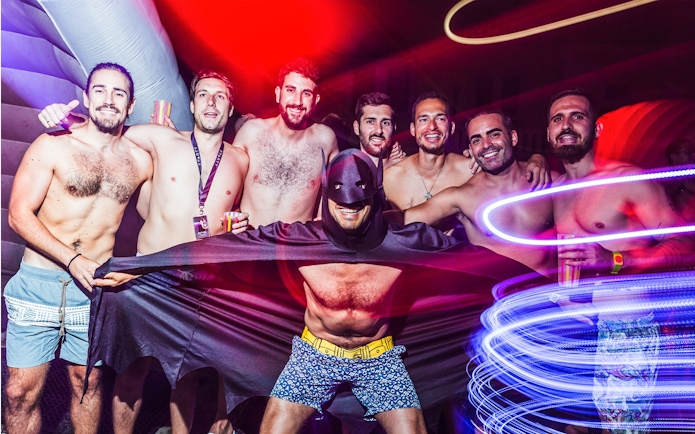 Group of friends enjoying Sparty bath party in Budapest with colorful lights.