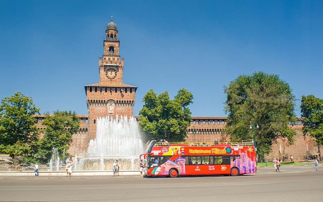 Hop on hop off tour bus in front of Sforzesco Castle, Milan.