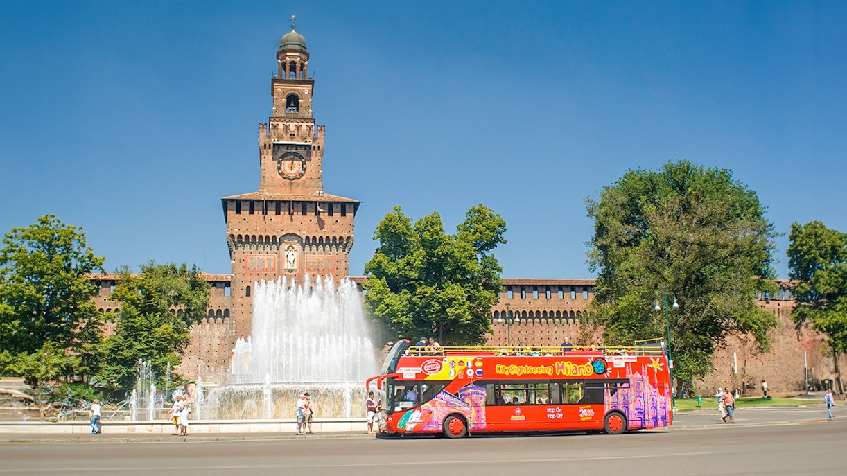Hop on hop off tour bus in front of Sforzesco Castle, Milan.