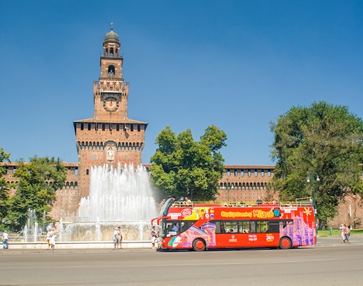 Hop on hop off tour bus in front of Sforzesco Castle, Milan.