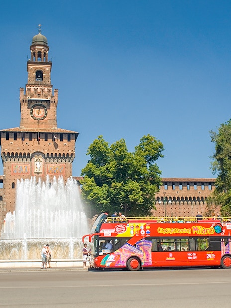 Hop on hop off tour bus in front of Sforzesco Castle, Milan.