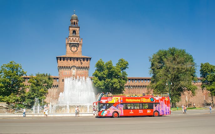 Hop on hop off tour bus in front of Sforzesco Castle, Milan.