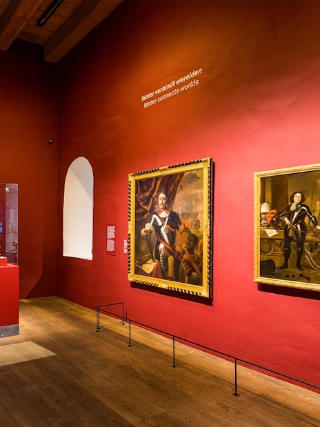 Exhibit of maritime artifacts and paintings inside The Maritime Museum, Amsterdam.