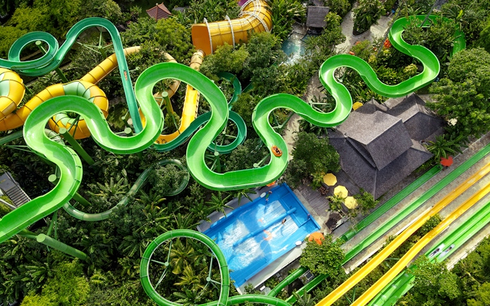 Aerial view of winding waterslides and wave pool at Waterbom Bali.