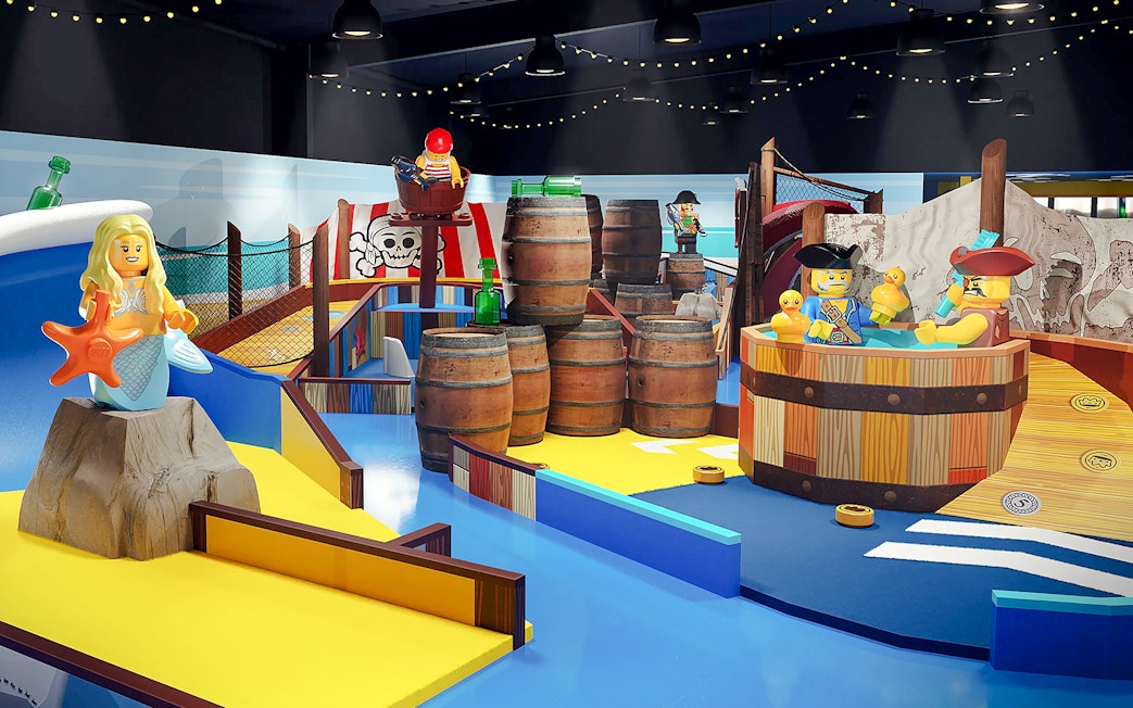 LEGOLAND® Adventure Golf pirate-themed mini golf course with LEGO figures and barrels.