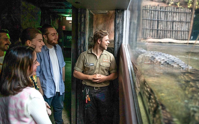 Group observing crocodile at WILD LIFE Sydney Zoo.