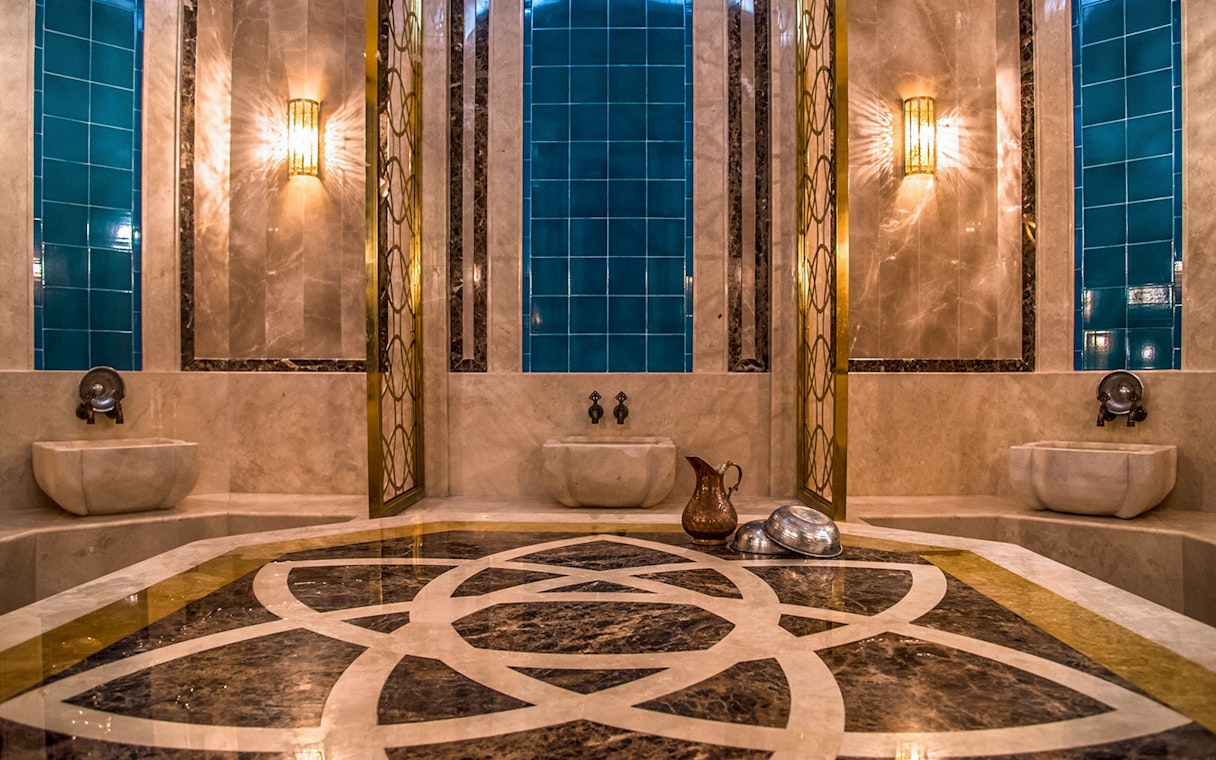 Private historical hammam bath interior with marble and blue tiles in Cappadocia, Turkey.